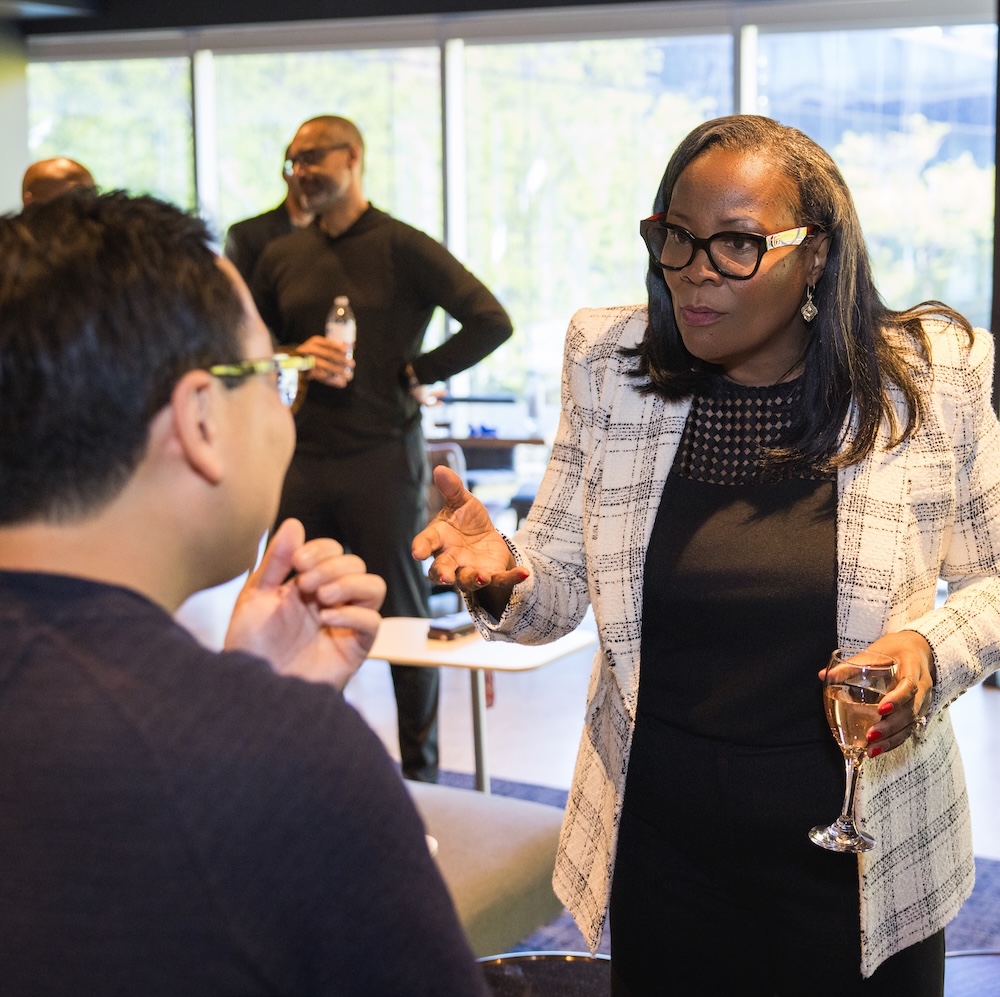 Two CLOC members talk at a networking reception